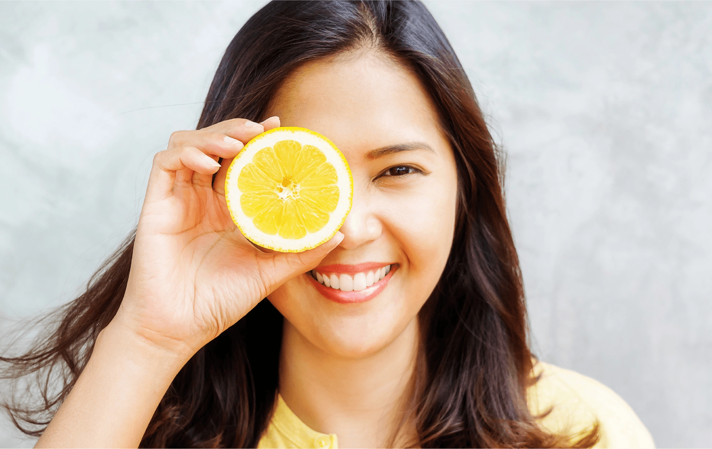 woman holding lemon slice